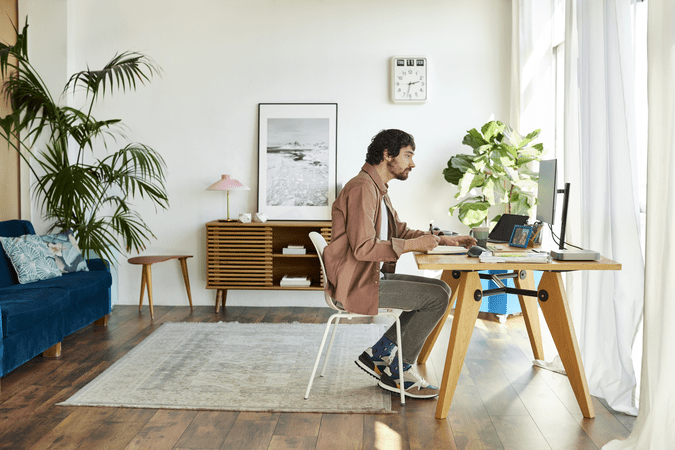 man sitting at desk working in home office