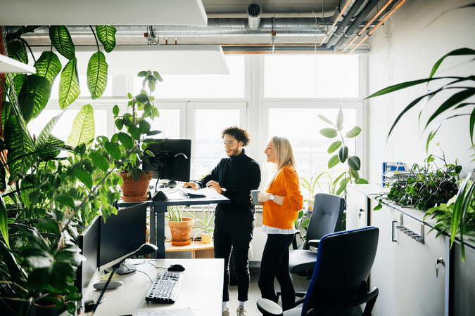 man and woman chatting at work in an office