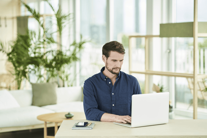 man working on laptop at desk