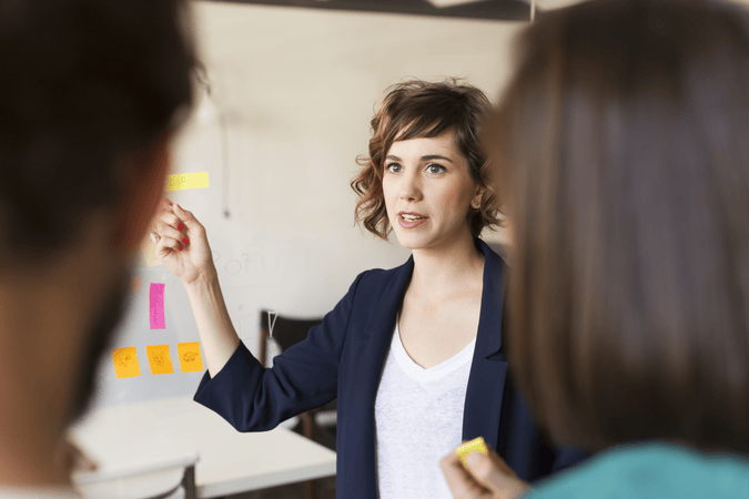 woman presenting in a meeting at work