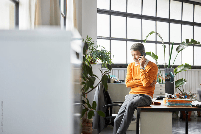 man talking on phone in an office