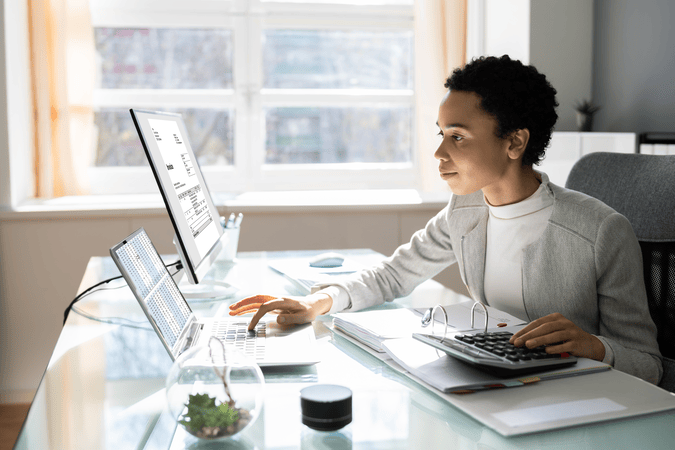 woman sitting at desk on computer