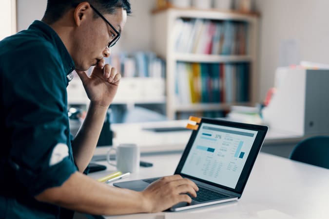 man working at laptop in office